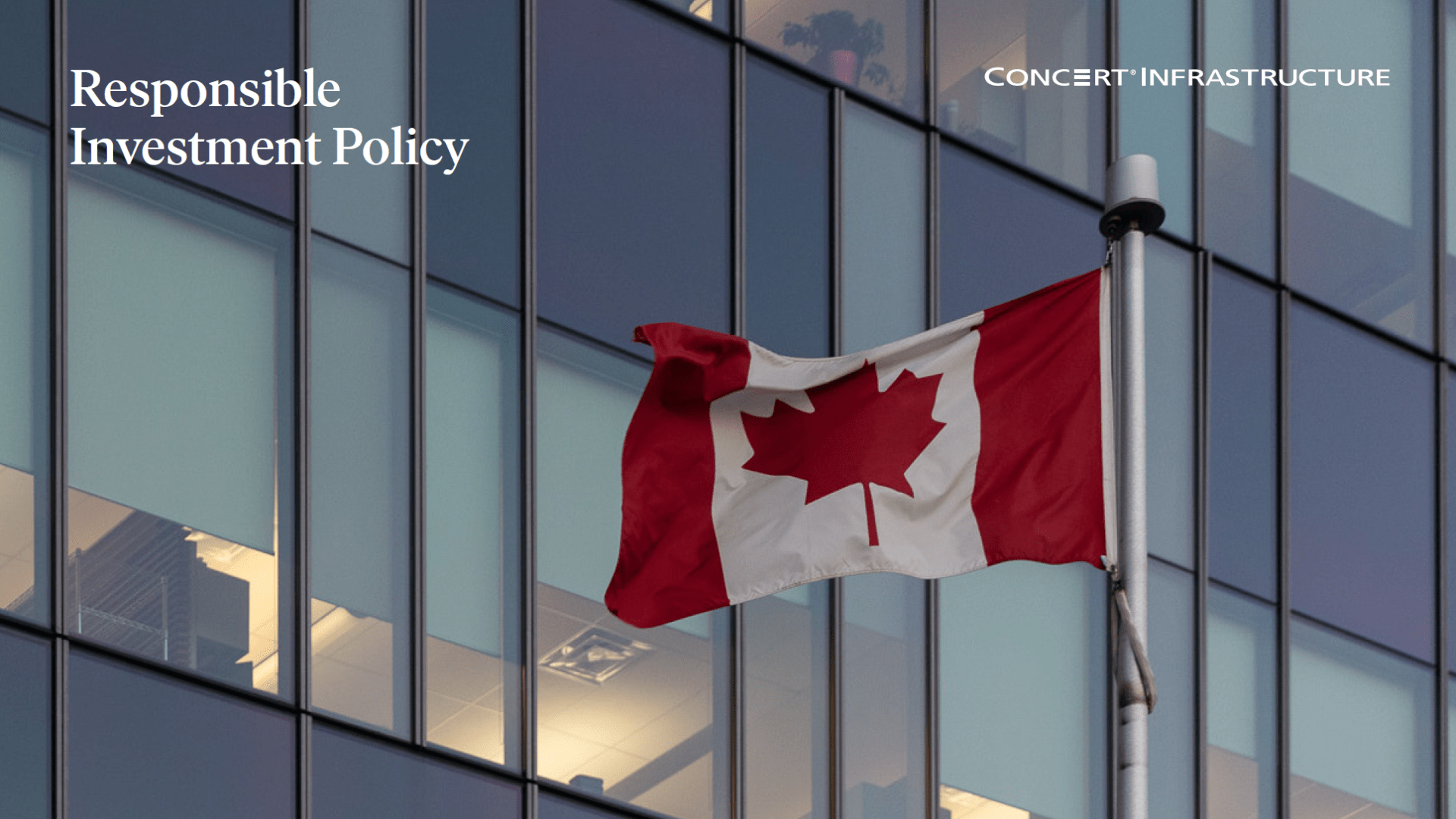Glass facade of an office building with Canadian flag waving 